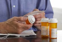 Cancer Breakthrough – Patients Thrive on Repurposed Drugs Person holding a prescription bottle and reading medical instructions