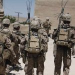 Deployed Marine Arrested on Suspicion of Robbing and Murdering Woman soldiers in desert fatigues with radio packs and antennas