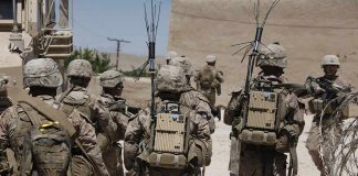 Deployed Marine Arrested on Suspicion of Robbing and Murdering Woman soldiers in desert fatigues with radio packs and antennas