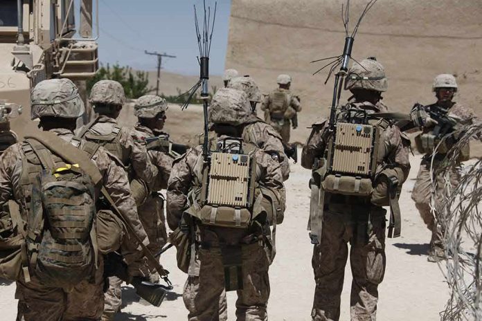 shutterstock_1470887795 soldiers in desert fatigues with radio packs and antennas