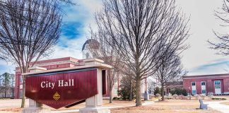 City Hall sign in front of a red-brick municipal building