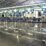 Airport check-in counters with empty queue barriers