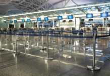 Airport check-in counters with empty queue barriers