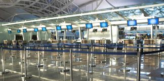 Airport check-in counters with empty queue barriers