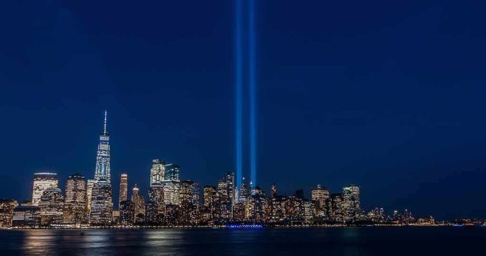 shutterstock_1742695205 City skyline at night with twin blue light beams rising into the sky