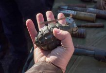 Hand holding a vintage hand grenade