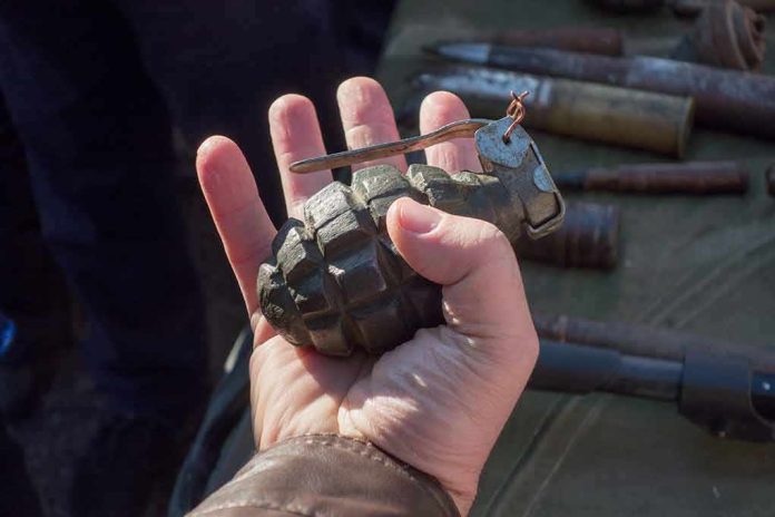 Hand holding a vintage hand grenade