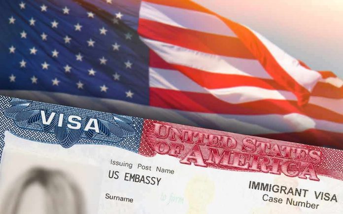 shutterstock_1983291833 US visa document with American flag in background