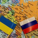 Ukraine and Russia flags on a map of Eastern Europe