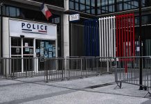 National Emergency – Curfew Hotspots Announced Police station entrance with barriers and French flag colors