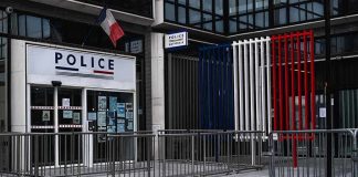 National Emergency – Curfew Hotspots Announced Police station entrance with barriers and French flag colors