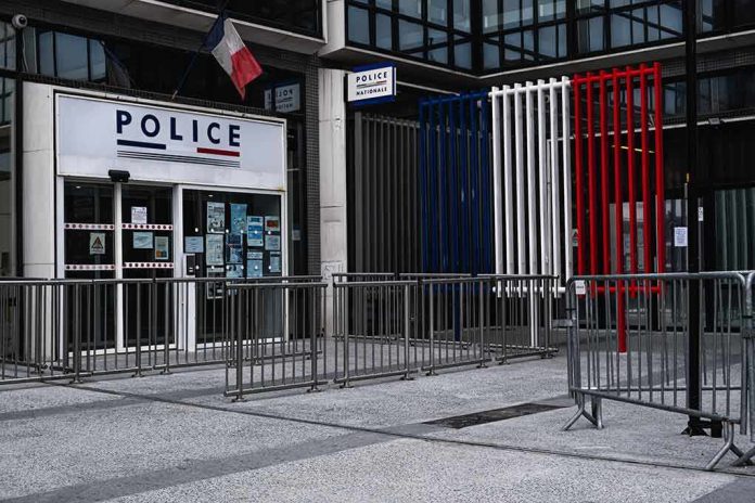 Police station entrance with barriers and French flag colors