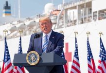 Trump Reveals MLB Icon to Receive Presidential Medal of Freedom Donald Trump speaking at a podium with American flags and a ship in the background
