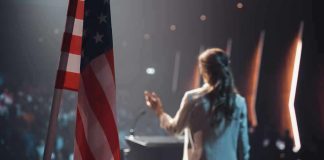 Candidate Holds Rally With Upside-Down Flag American flag and speaker at podium addressing audience