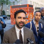 Mamdani Defies Trump, Spends Millions on Trans Drugs Zohran Mamdani speaking to reporters on a city sidewalk