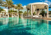 Resort pool with cabana and palm trees