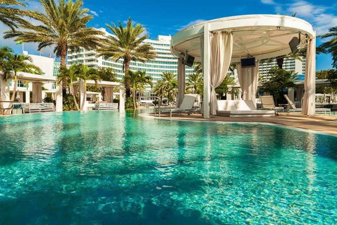 shutterstock_285010052 Resort pool with cabana and palm trees