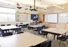 First Grader to Police: “I Don’t Care If I Go To Jail” Empty classroom with tables, chairs, and a whiteboard