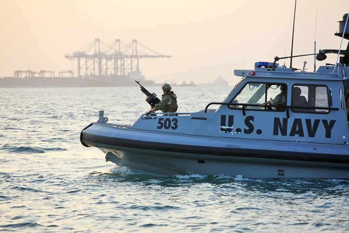 shutterstock_389280448 U.S. Navy patrol boat with armed crew on the water