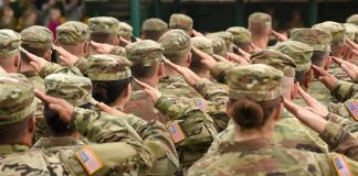 TRUMP Greenlights First Military Execution in 60 Years Soldiers in camouflage uniforms salute in formation