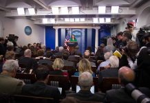 Trump Bares Teeth at Reporter – Oval Office Stunned! Press secretary at podium addressing reporters in briefing room